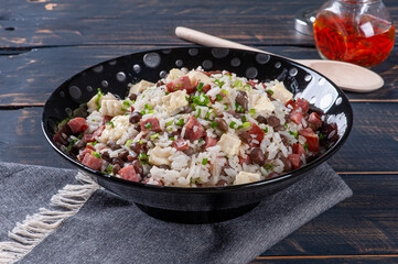 .Brazilian food called Baião de Dois. Very common in the north of the country. Made with rice, beans, sausage and rennet cheese.