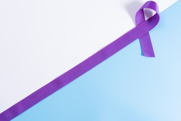 World cancer day, purple ribbon on with and blue background with copy space for text. Healthcare...