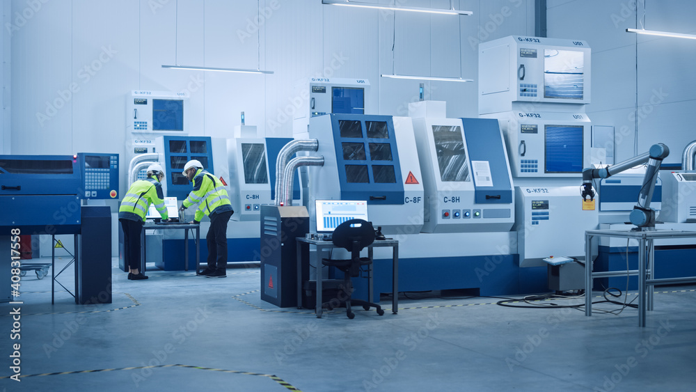 Poster Chief Engineer and Project Manager Wearing Safety Vests and Hard Hats Work on Computer, Talk, Optimize Production Line. On Foreground: industry 4.0 Modern Factory with CNC Machinery and robot arm