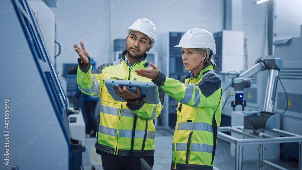 Fototapete Chief Engineer and Project Manager Wearing Safety Vests and Hard Hats, Use Digital Tablet Controller in Modern Factory, Talking, Optimizing CNC Machinery, Programming Machine for Increasing Efficiency