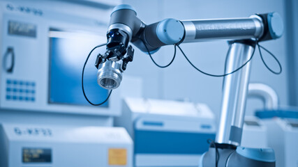 Industry 4.0 Modern Factory: Programmed robot arm Packing Metal Components into Cardboard Box. Production Line Machine Picks Packs Product into Package on Conveyor. Fully Automated Warehouse Robotics