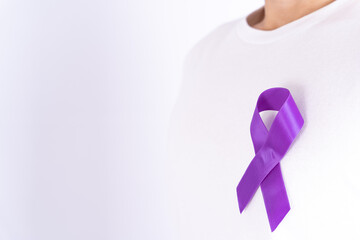 World cancer day, purple ribbon on chest isolated grey background. Healthcare and medical concept.