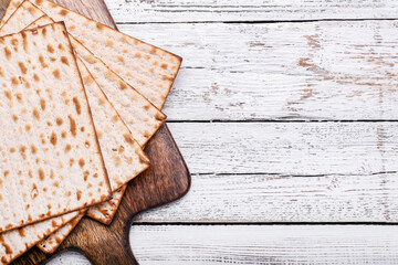 Jewish flatbread matza for Passover on wooden background