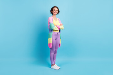 Photo portrait full body three-fourths view of girl with folded arms isolated on pastel blue colored background