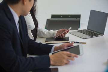 Portrait of Start-up Asia business team in meeting and helped analyze the marketing problems of the company or beginning new project. Start up concept