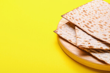 Plate with Jewish flatbread matza for Passover on color background, closeup
