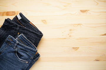 Jeans on a wooden background place for text, top view.