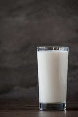glass of milk on a wooden table with