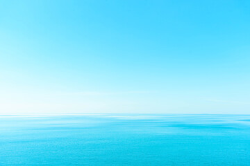 Obraz premium Vintage and retro toning of tropical beach with blue sky and clear sea which including of a wooden umbrella and chair in sunrise time with vintage retro tone. Vacation time as concept.