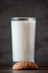 glass of milk and oatmeal cookies on a wooden table