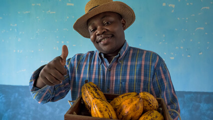 African American man carrying a box of fresh Cacao
