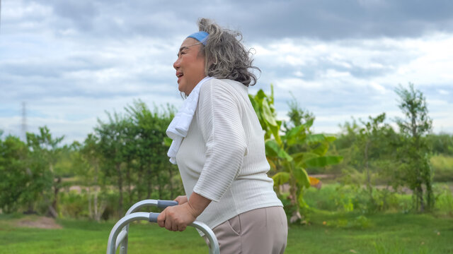 Asian senior retired woman using walking frame