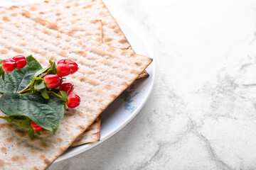 Plate with Jewish flatbread matza for Passover on light background, closeup