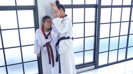 Teacher teaching taekwondo girl