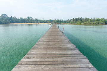 Naklejka premium Wooden bridge on sea for entry to the beautiful island.