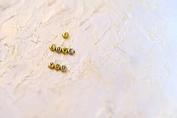 Partial blurred golden letters words i Love you on abstract solid background coating putty with pearlescent paint . love in valentine's day concept