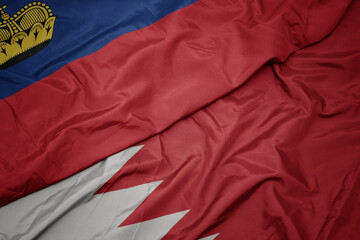 waving colorful flag of bahrain and national flag of liechtenstein.