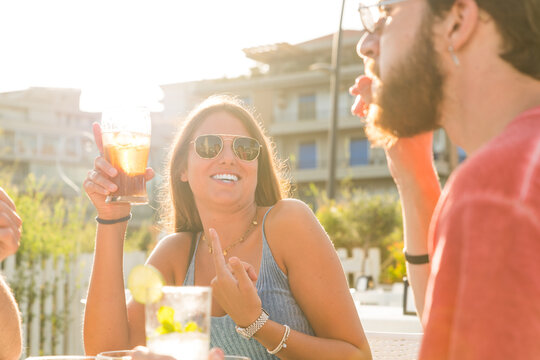 Young Friends drinking cocktails in an outdoors