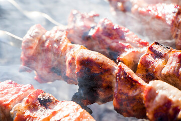Georgian traditional dish, Mtsvadi on the fire, raw meal on the grill, barbeque