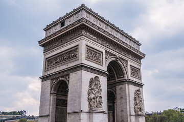 Fototapeta na wymiar Architectural fragment of Arc de Triomphe. Arc de Triomphe de l'Etoile on Charles de Gaulle Place is one of the most famous monuments in Paris. France.