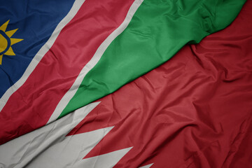 waving colorful flag of bahrain and national flag of namibia.