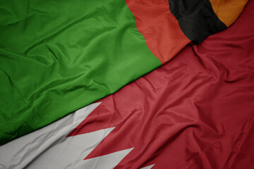 Fototapeta na wymiar waving colorful flag of bahrain and national flag of zambia.