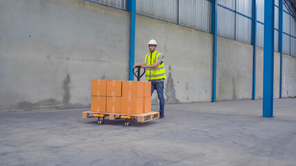 Smiling warehouse workers preparing a shipment in a large warehouse