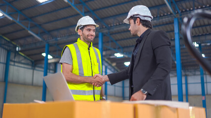 Warehouse worker and manager checking product in a large warehouse