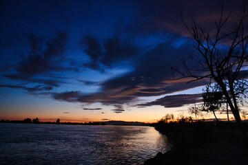Fototapeta na wymiar Sunset near a big river