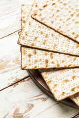 Jewish flatbread matza for Passover on wooden background