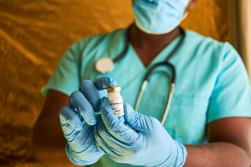 Doc holding vaccine vial close up