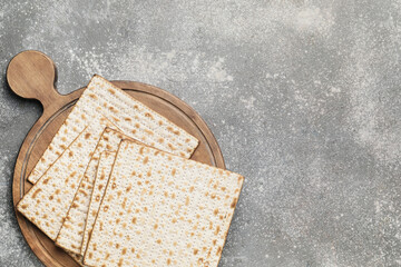 Jewish flatbread matza for Passover on grey background