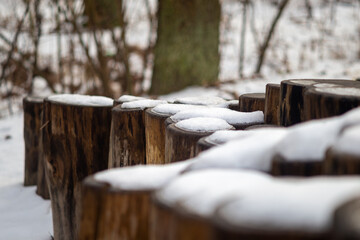 snow-covered wooden piles