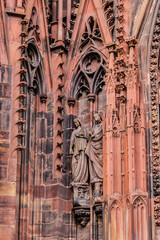 Naklejka premium Architectural fragments of Strasbourg Cathedral Main Portal (Cathedral of Our Lady of Strasbourg or Cathedrale Notre-Dame de Strasbourg, 1439) - Roman Catholic cathedral in Strasbourg, Alsace, France.