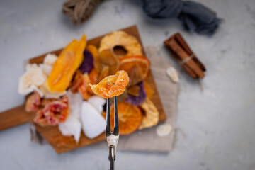 dried fruits. Assorted dried fruits on a cutting board on a concrete background.