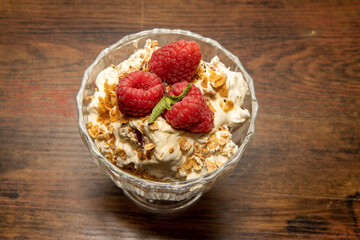 A delicious creamy desert topped with raspberries.