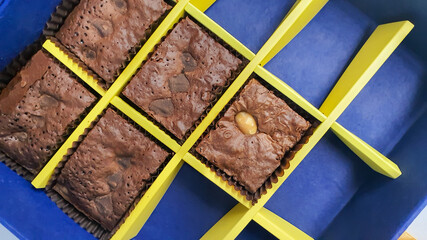 brownie cookies in blue and yellow grid pattern paper box.