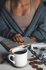 Woman reading a book and having breakfast. Top view. Healthy healthy breakfast.