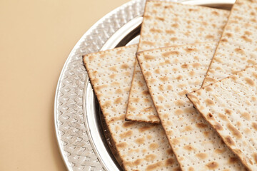Passover Seder plate with Jewish flatbread matza on color background, closeup