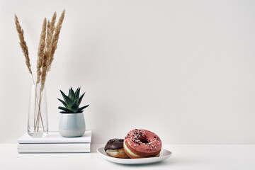 Mug and donuts cakes on a white background. Confectionery, coffee shop. Copy space, mock up.