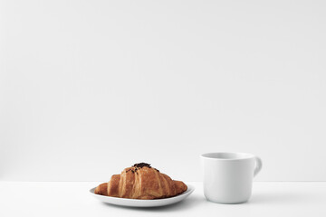 White mug and croissants on a white background. Eco-friendly and natural materials in the decor, dessert. Copy space, mock up