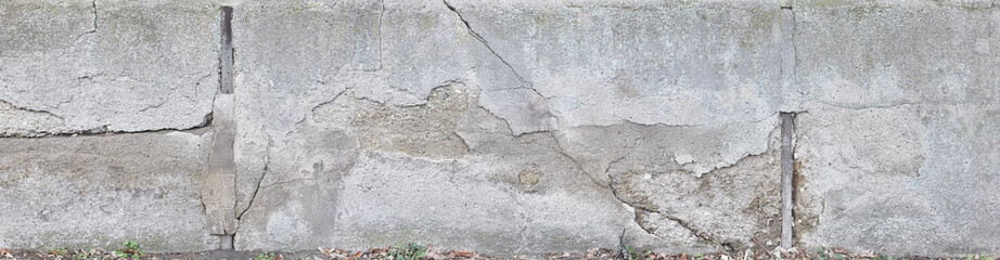 Old crumbling concrete wall in panoramic format.