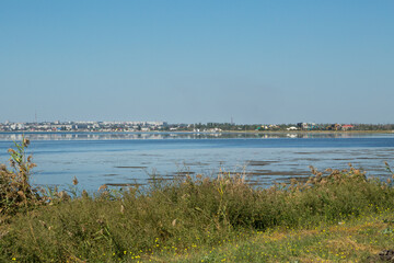Fototapeta na wymiar City landscape across the bay with water reflection.