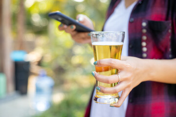 A close up of a beer with a phone playing