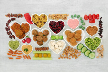 Vegan health food for ethical eating with plant based foods high in protein, fibre, antioxidants, anthocyanins, vitamins, minerals, omega 3, smart carbs. Heart health foods. On rustic wood. Flat lay.