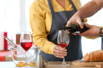 Mature couple celebrating Valentine's Day while cooking festive dinner