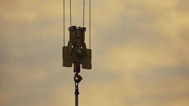close up of construction crane hanging in the air,  hard work lifestyle