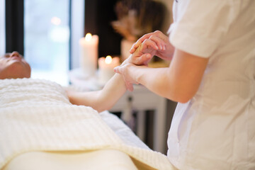Wrist massage. massage therapist puts pressure on a sensitive point on a woman's hand....