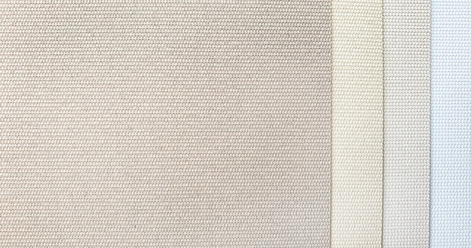 close up roman blind or roller blind linen fabric texture samples in color chart. warm tone color of textile fabric with sunproof function for home or office . interior material selection.