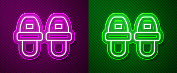 Glowing neon line Hotel slippers icon isolated on purple and green background. Flip flops sign. Vector.